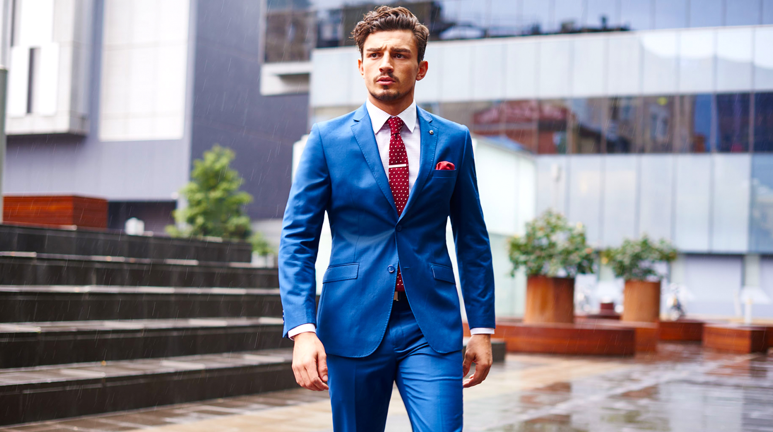 Contrasting colors scheme: Blue suit and a red tie