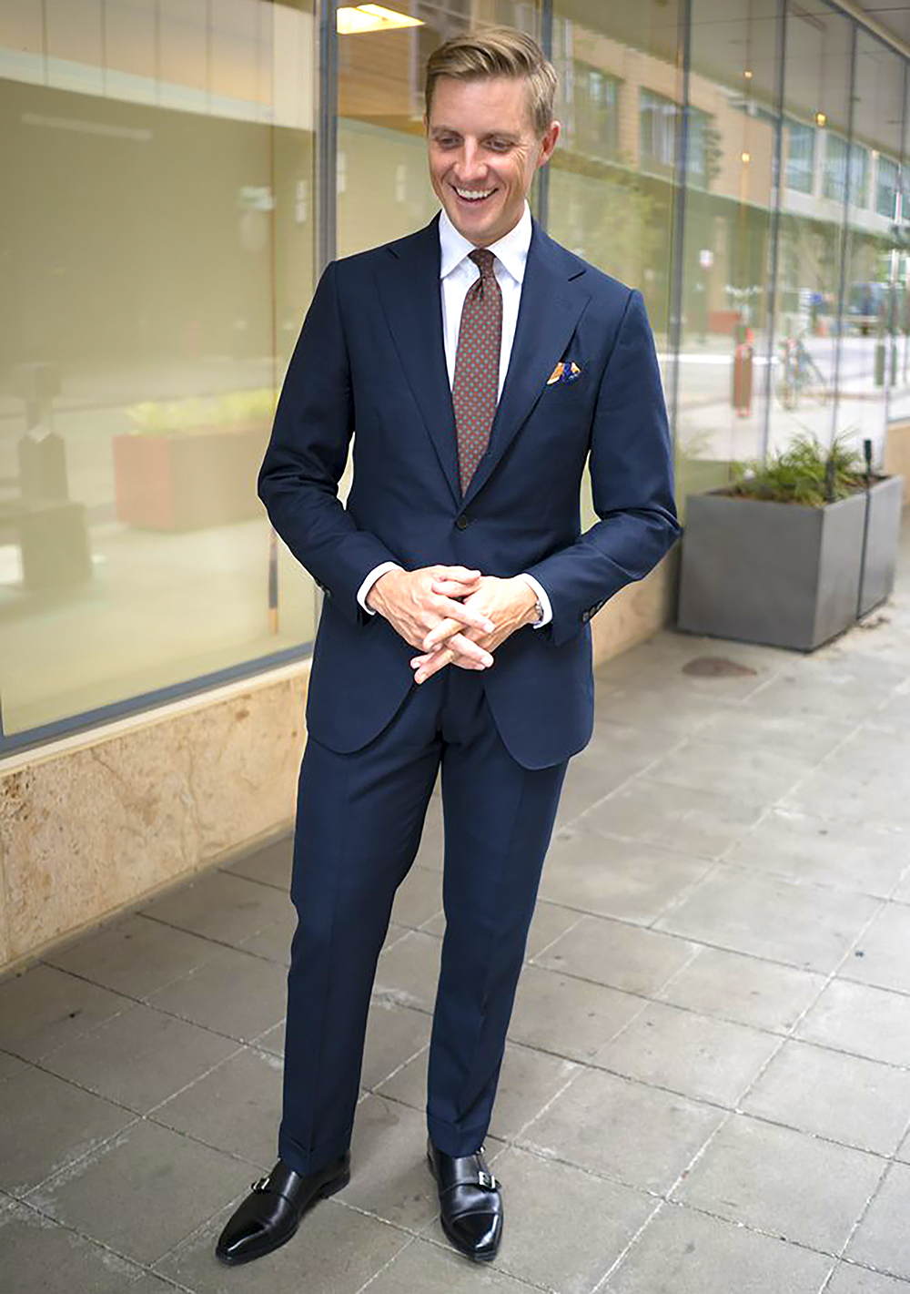 Navy suit with white shirt, black shoes and brown tie