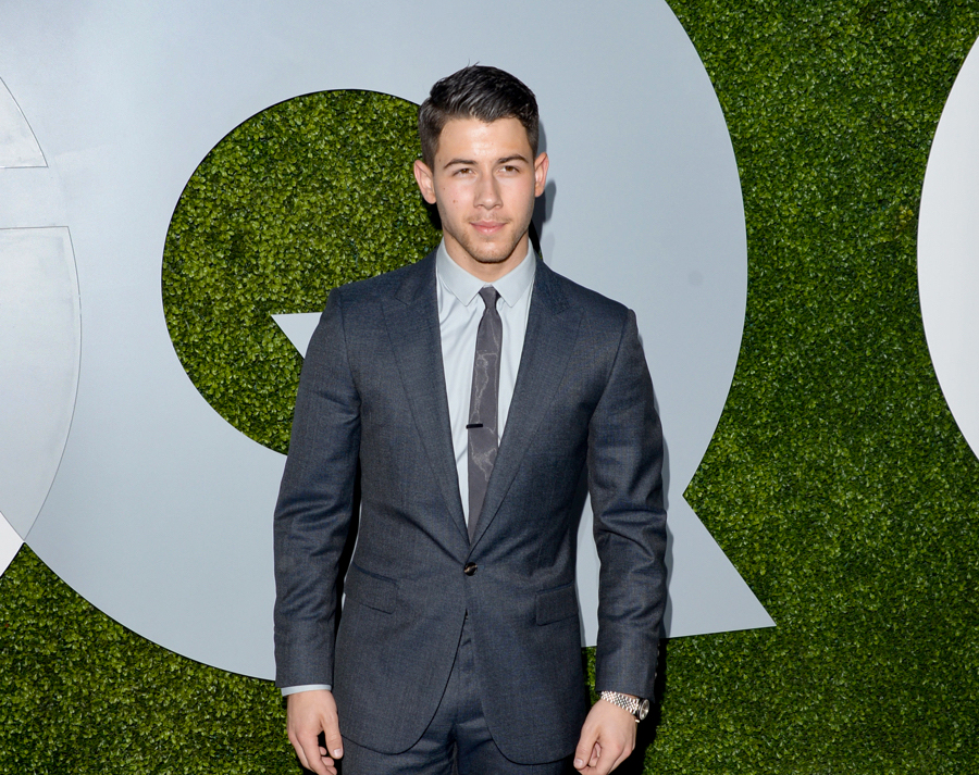 Nick Jonas wears a Calvin Klein suit