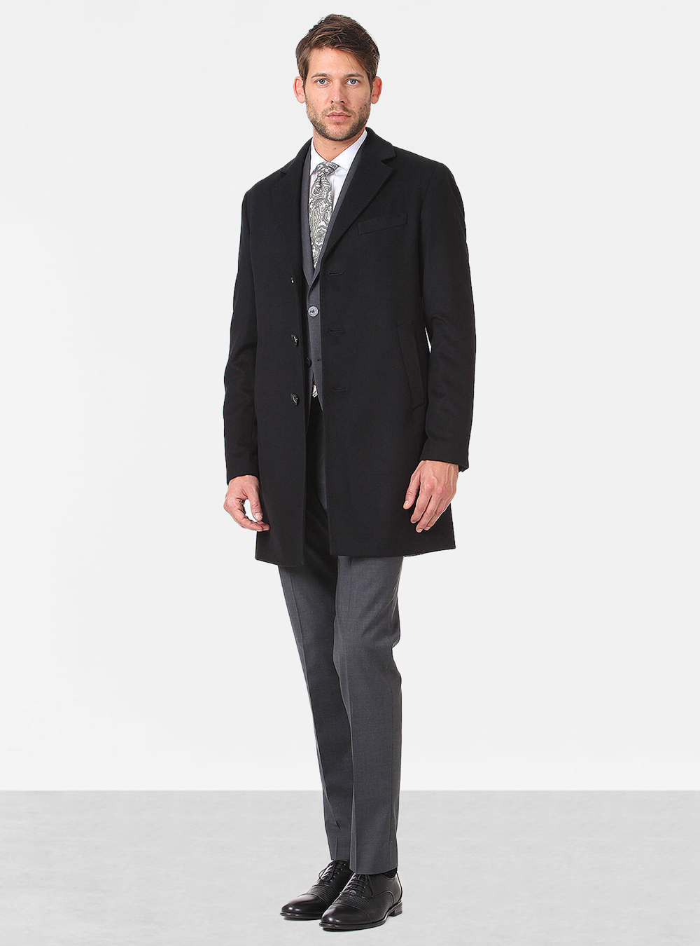 black overcoat with a charcoal grey suit