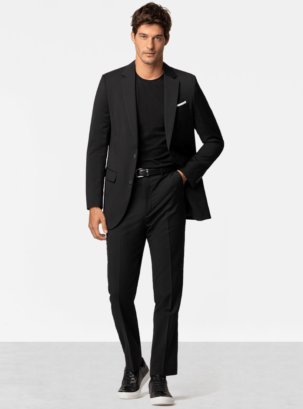 Black suit, black crew neck t-shirt and black sneakers