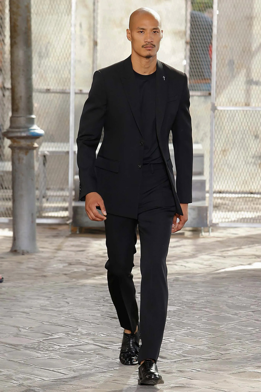 black suit, black t-shirt, and black derby shoes