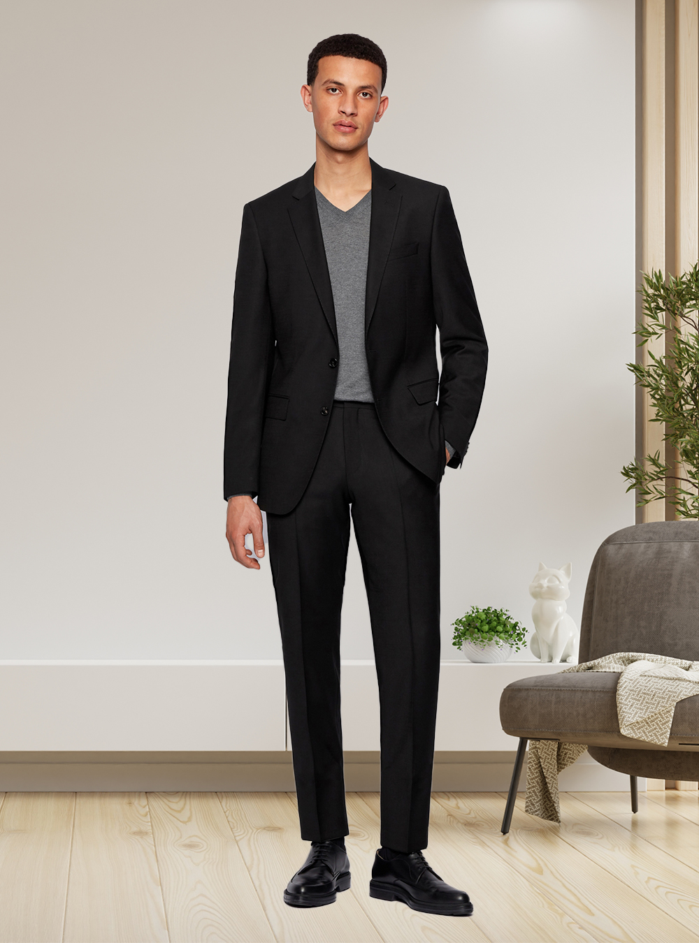 black suit, grey v-neck, and black derby shoes