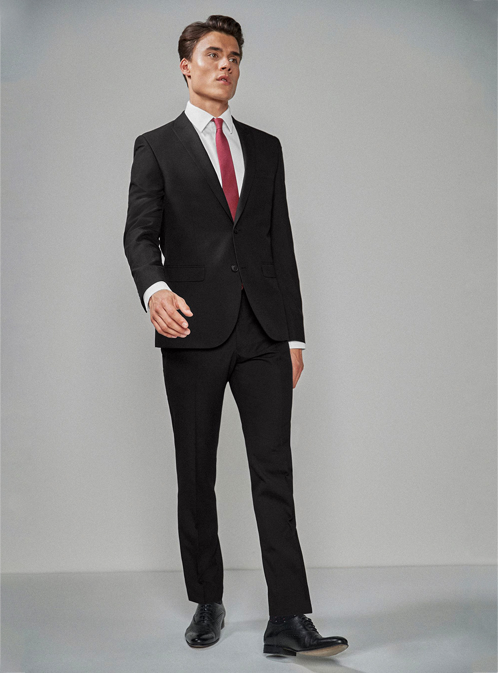 Black suit, white dress shirt, red tie and black brogue shoes