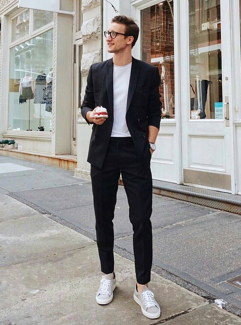 black suit, white t-shirt, and light grey sneakers