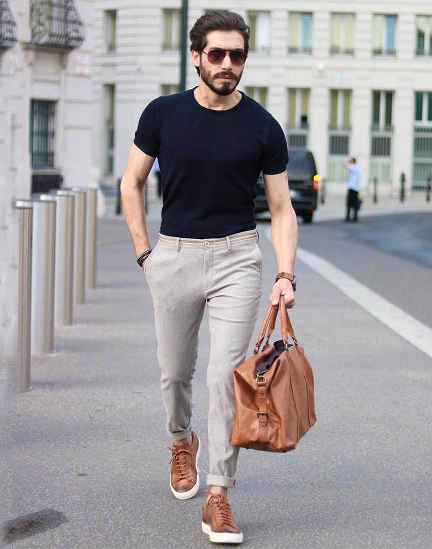 black t-shirt, grey chino pants, and brown sneakers