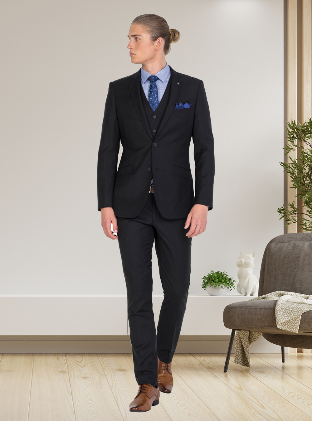 black three-piece suit, blue dress shirt, navy tie, and brown derby shoes