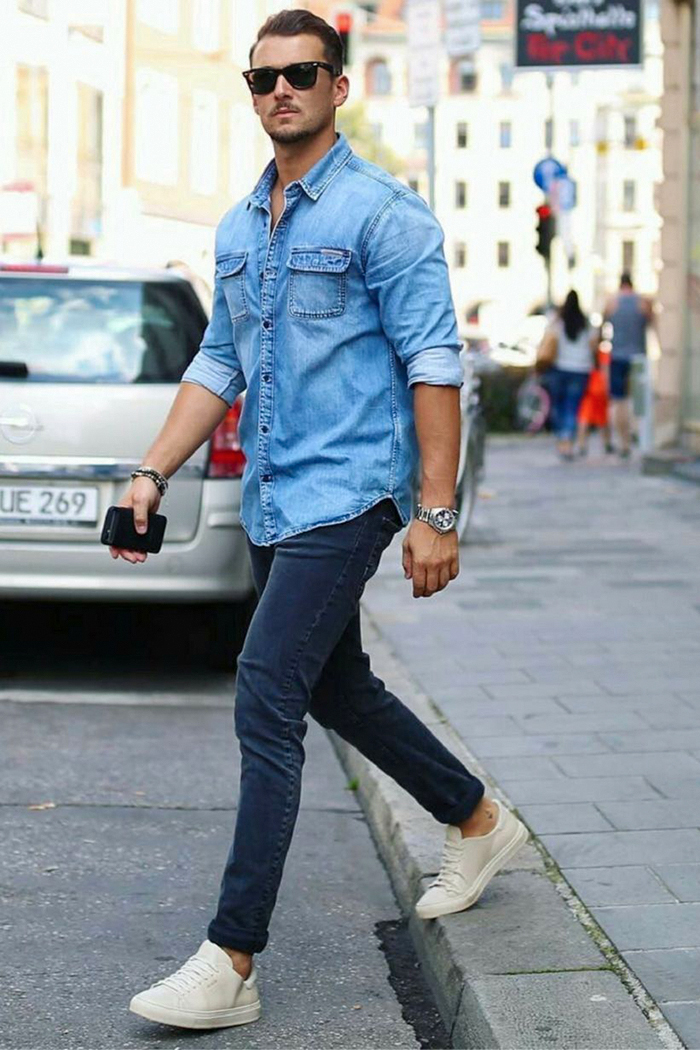 blue denim shirt, dark blue denim jeans, and white sneakers