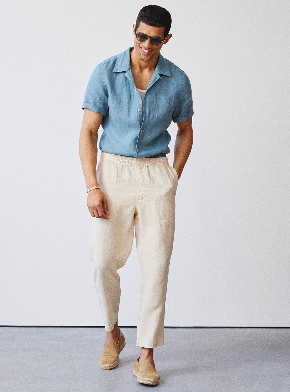 blue shirt, beige linen pants, and tan loafers
