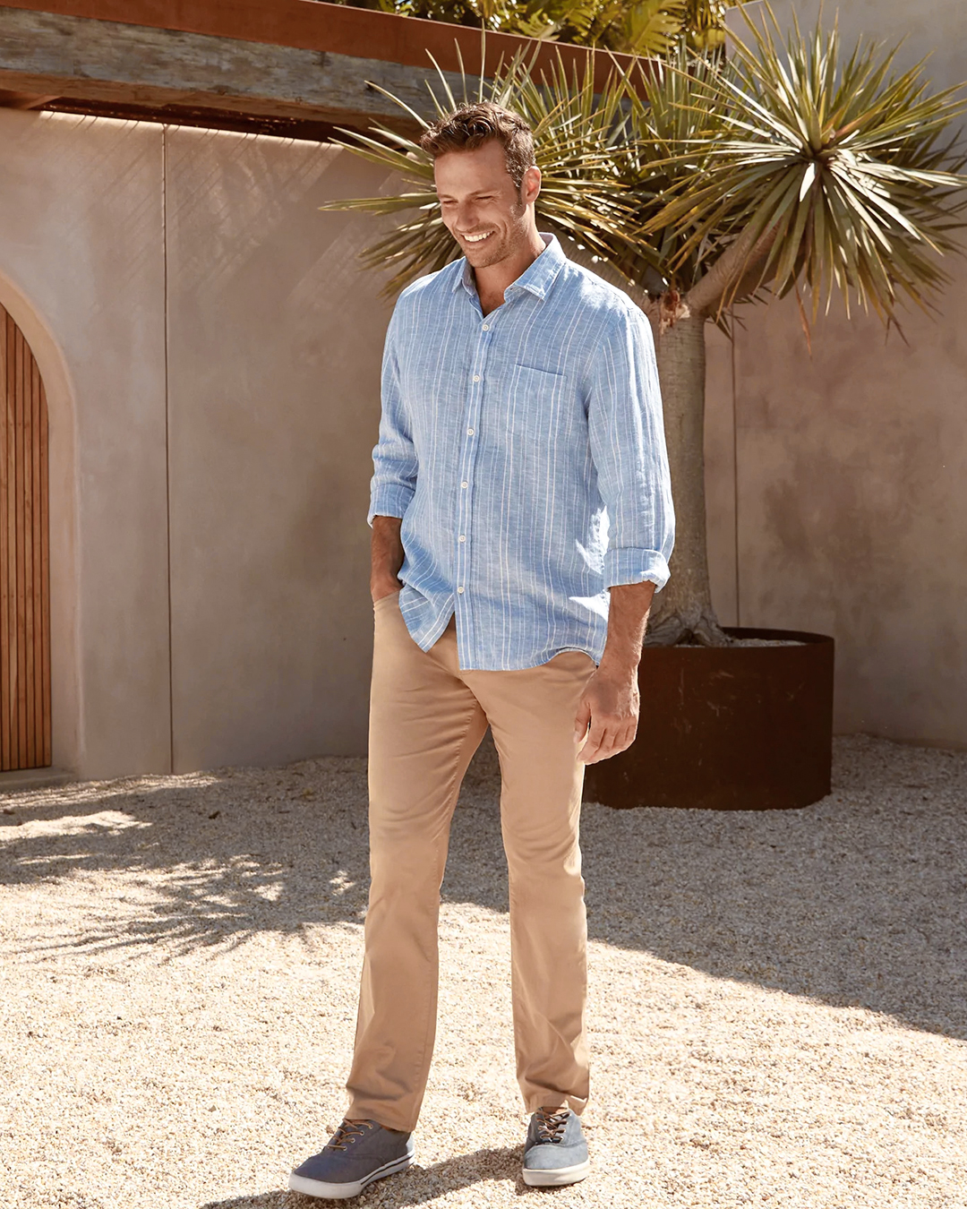 blue striped shirt, khaki chino pants, and blue sneakers