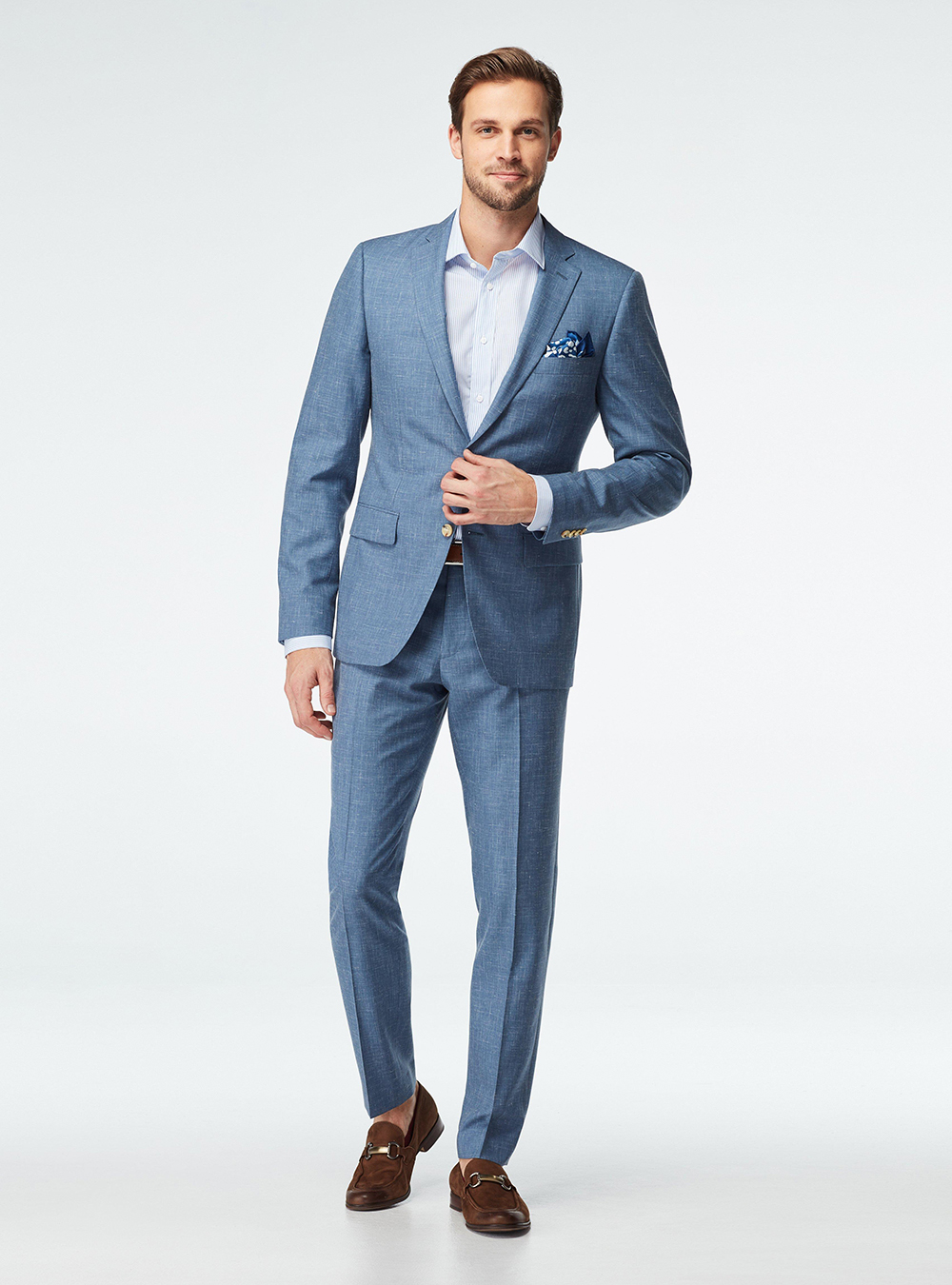 blue suit, light blue dress shirt, and brown loafers