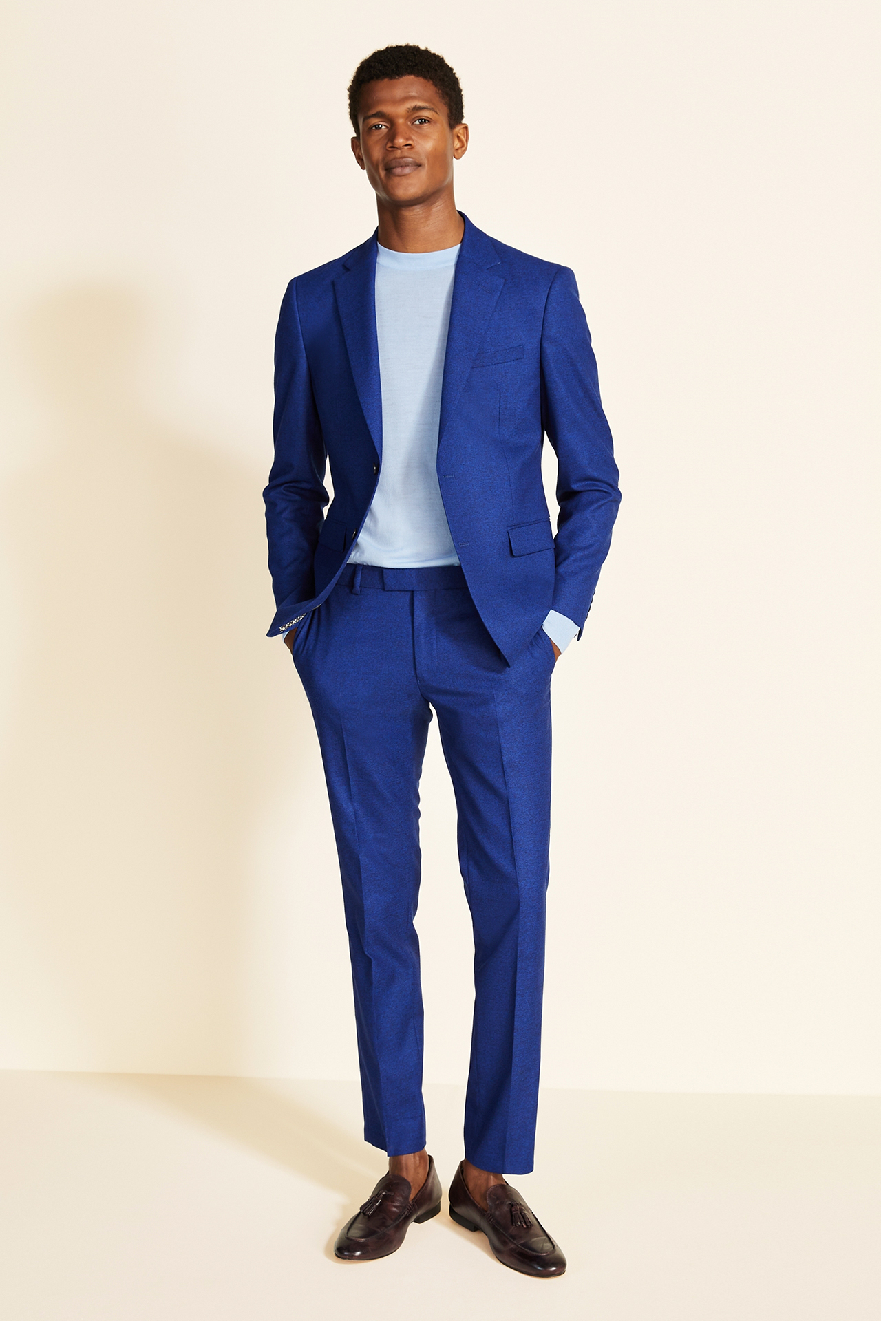 blue suit, light blue t-shirt, and brown loafers