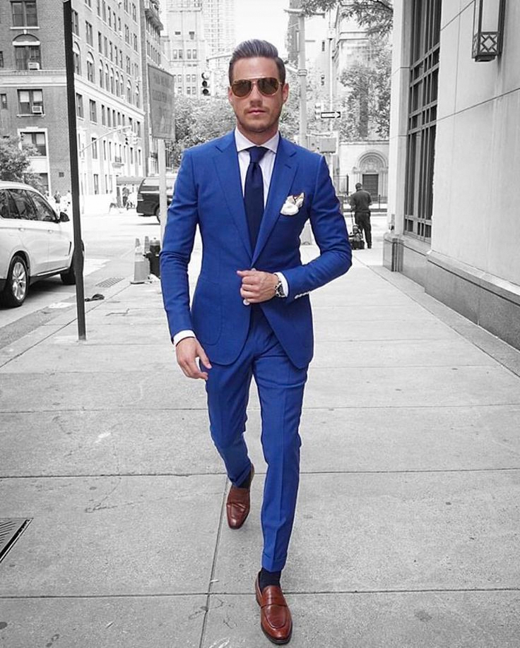 Blue suit, white shirt, navy tie, and brown loafers