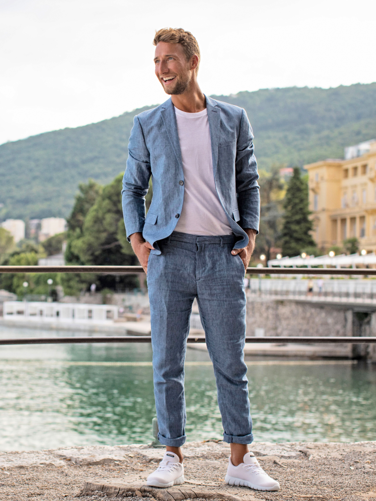 blue suit, white t-shirt, and light grey sneakers