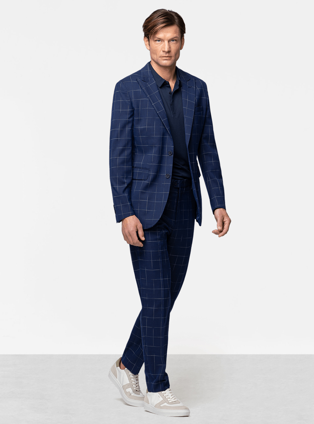 Blue windowpane suit, blue polo t-shirt and white sneakers