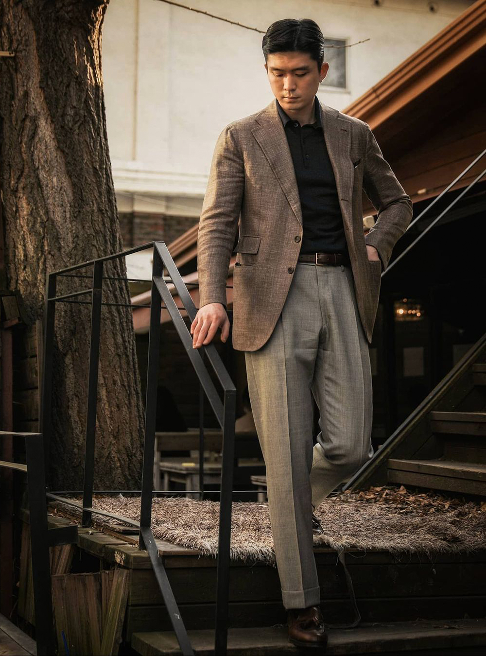 brown blazer, black polo T-shirt, grey dress pants, and brown loafers