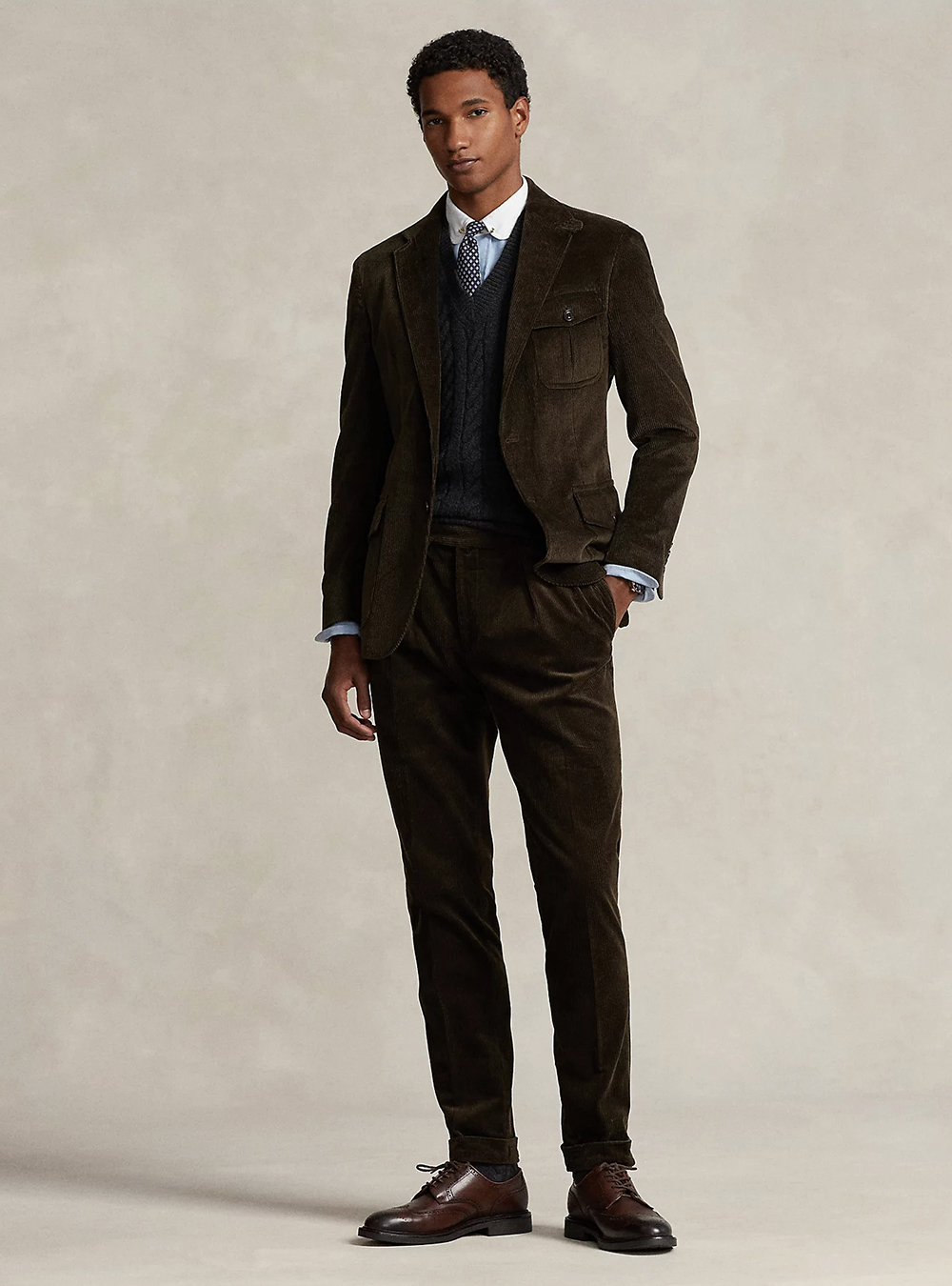 brown corduroy suit, navy sweater, white shirt, and brown derby shoes