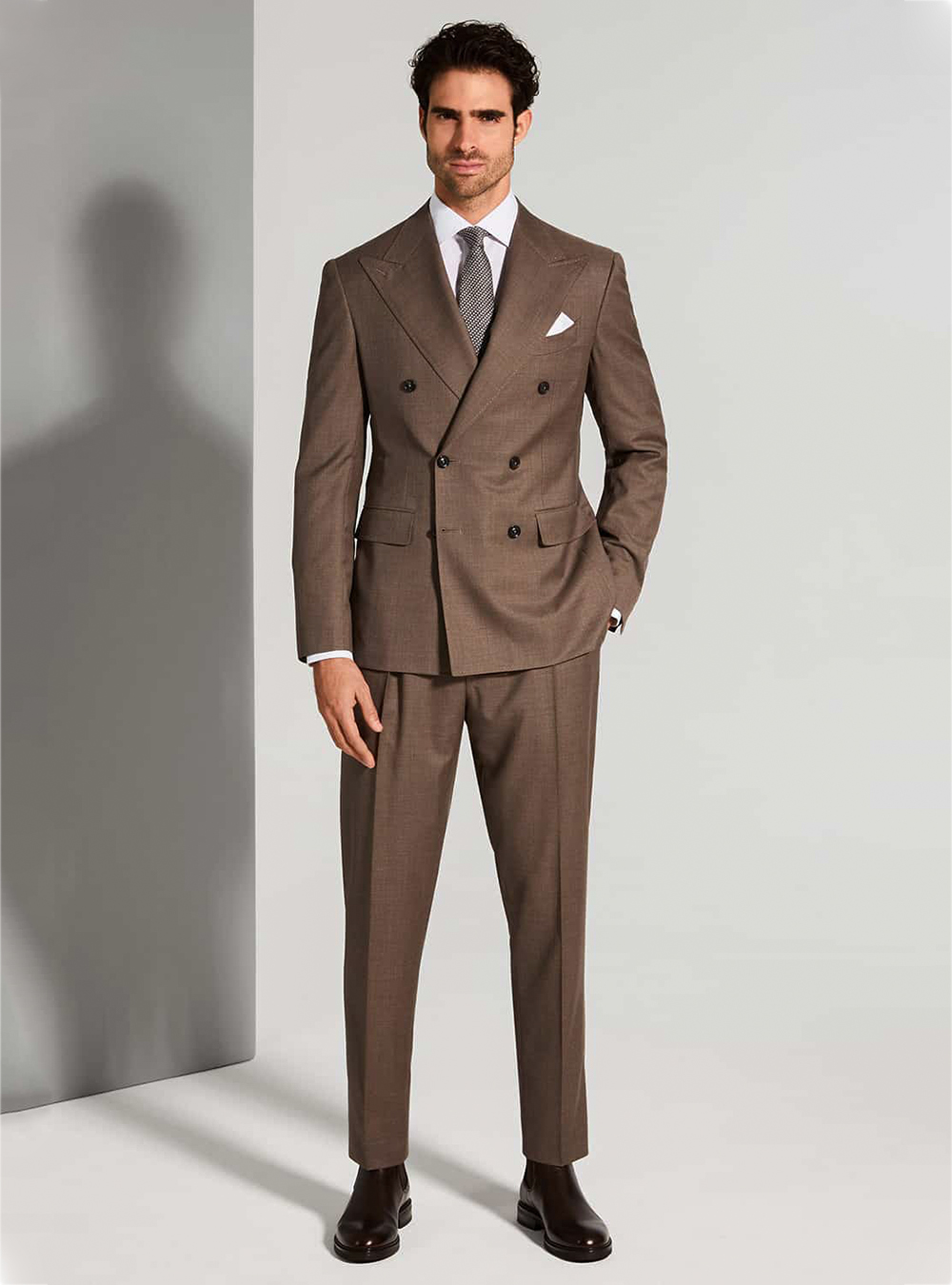 Brown double-breasted suit, white dress shirt, grey dotted tie and brown Chelsea boots