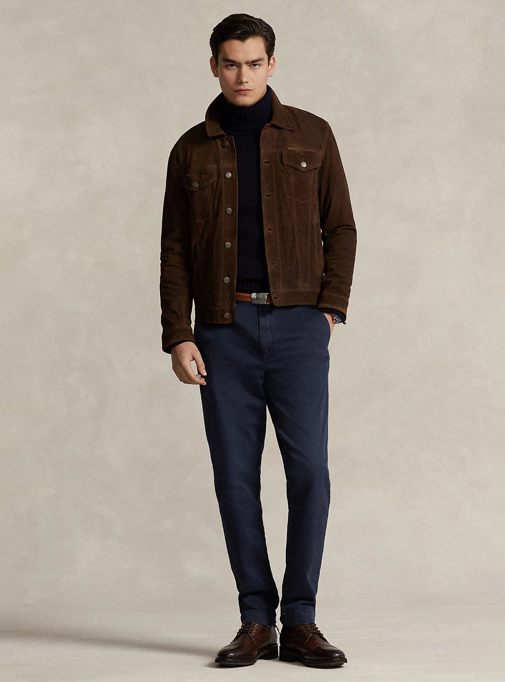 brown suede jacket, black turtleneck, navy chinos, and brown derby shoes