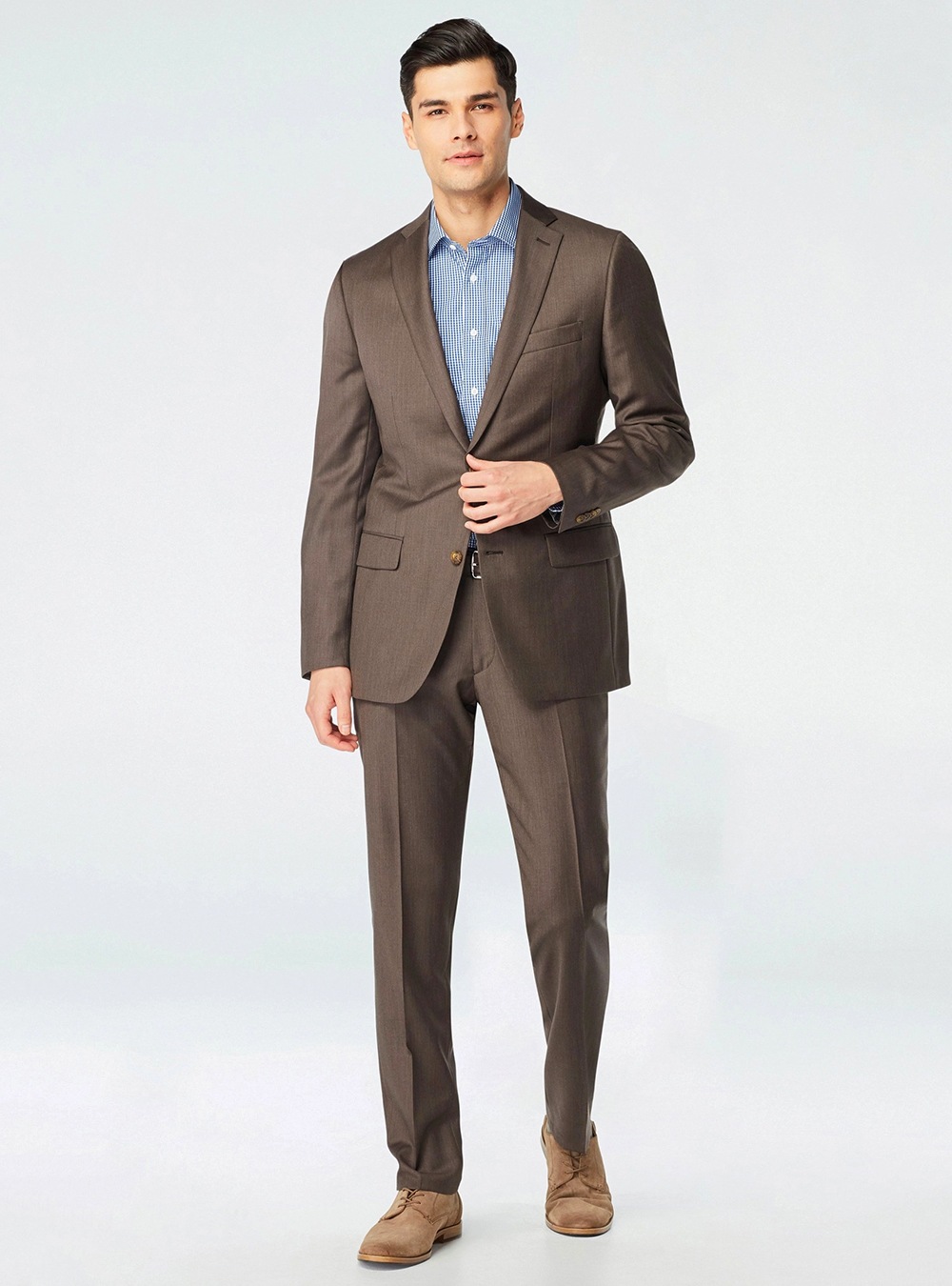 brown suit, blue striped shirt and tan derby shoes