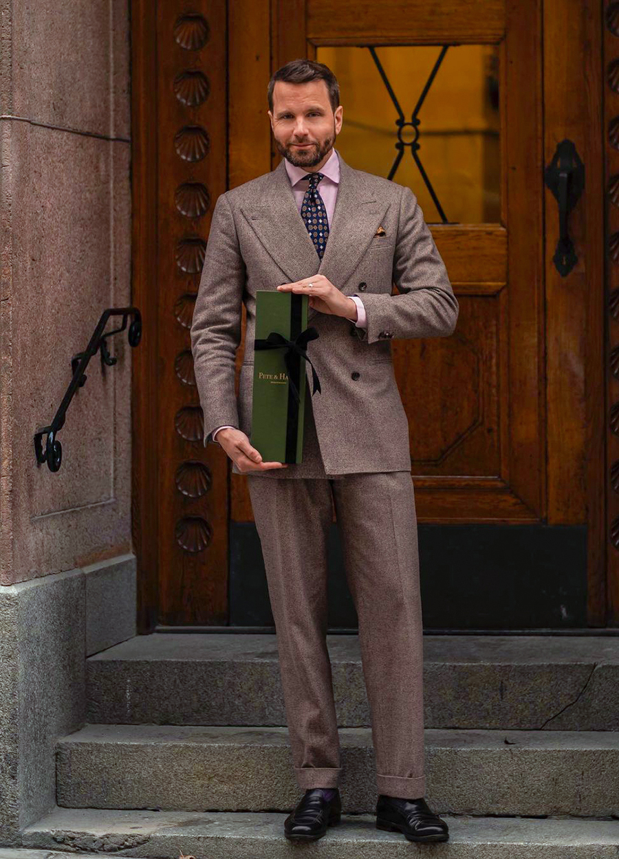 brown suit, pink shirt, and navy foulard tie