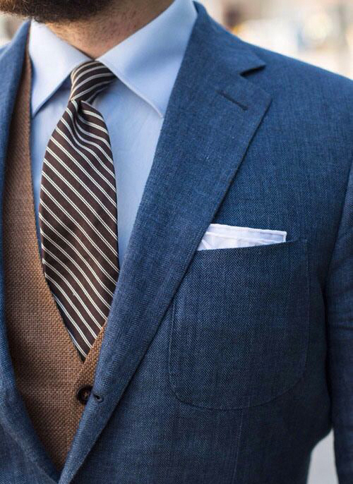 Brown vest with blue jacket, pale blue shirt and brown tie