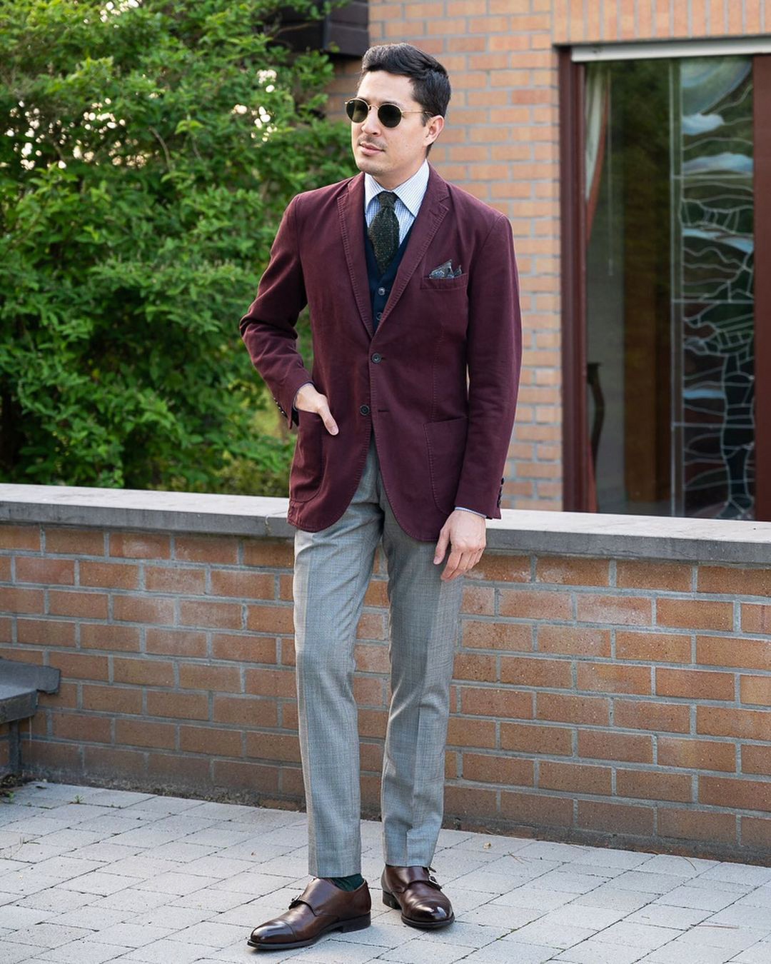 Burgundy corduroy blazer, blue checked shirt, light grey trousers, and brown monk strap shoes