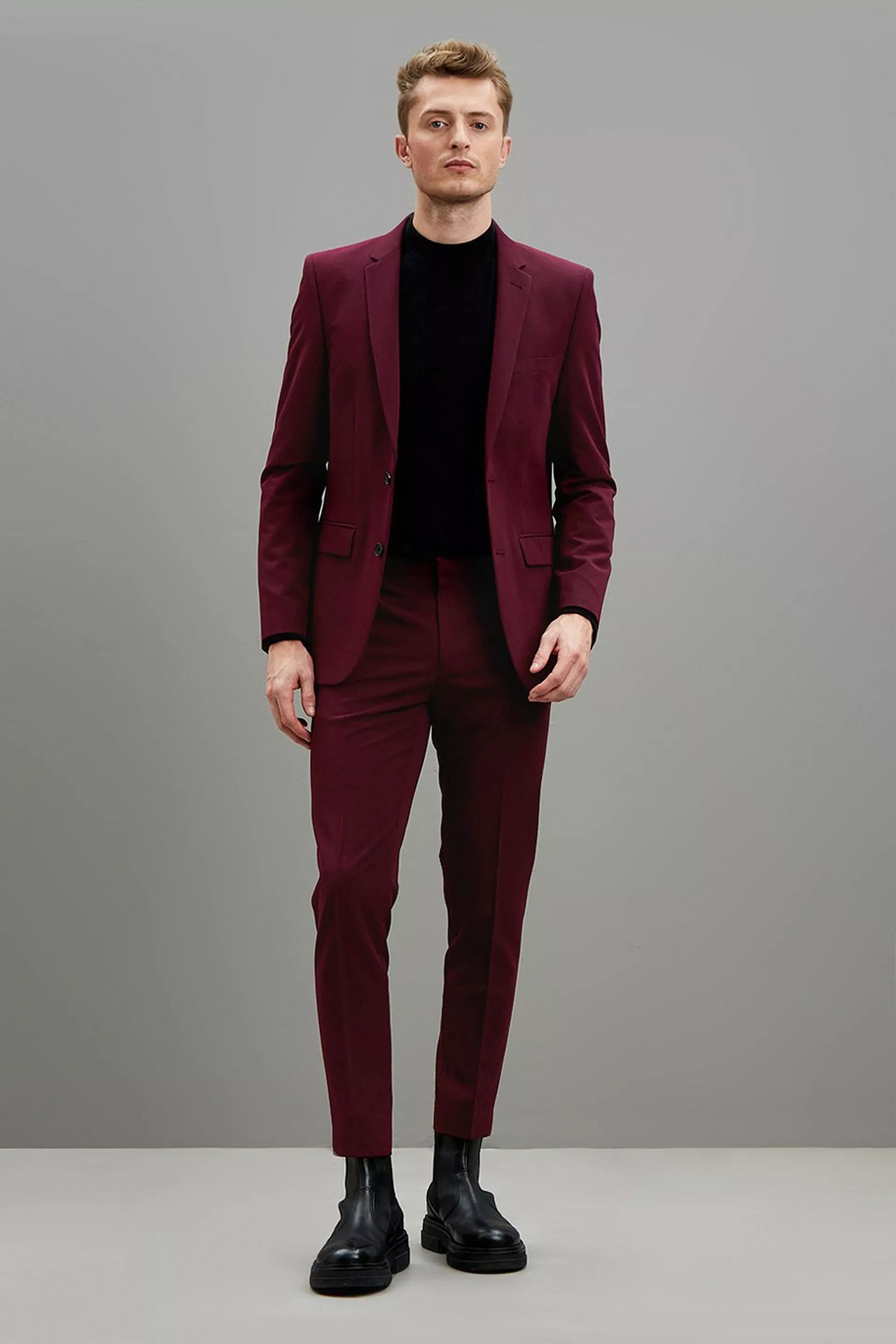 burgundy suit, black long-sleeve t-shirt, and black dress boots