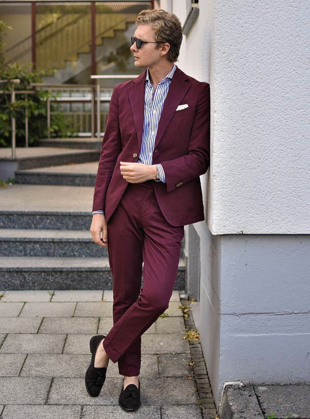burgundy suit, patterned navy blue shirt, and black loafers