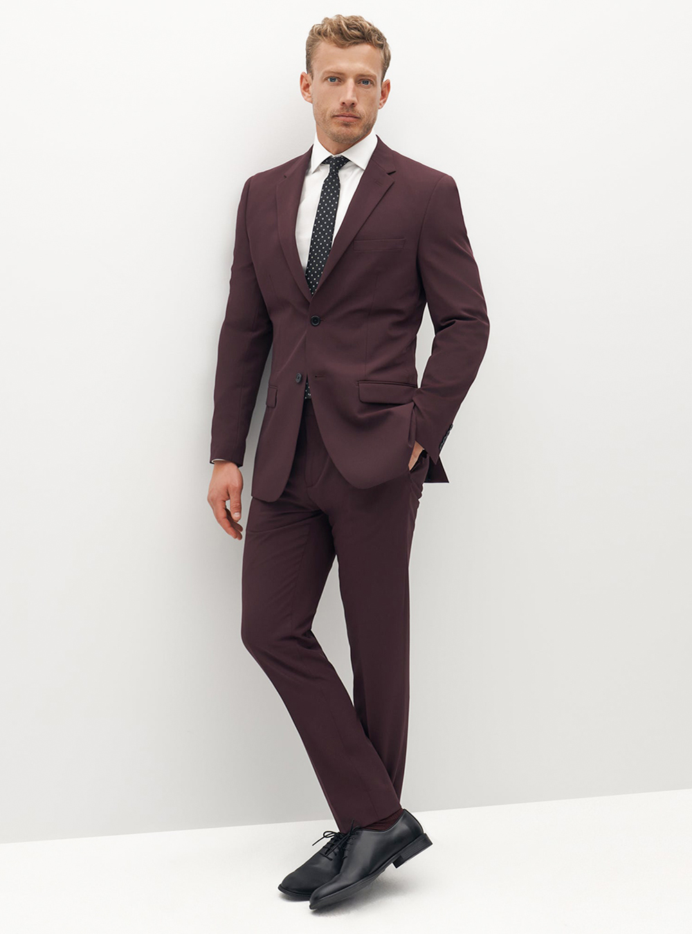 Burgundy suit, white dress shirt, black dotted tie and black oxford shoes