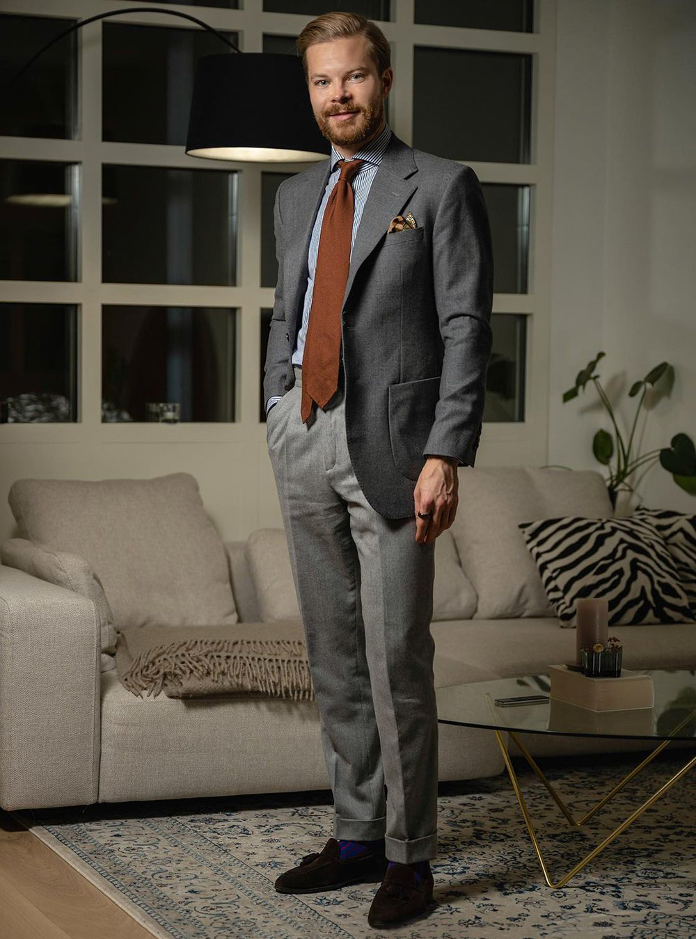 charcoal blazer, navy striped shirt, grey pants, and brown suede loafers