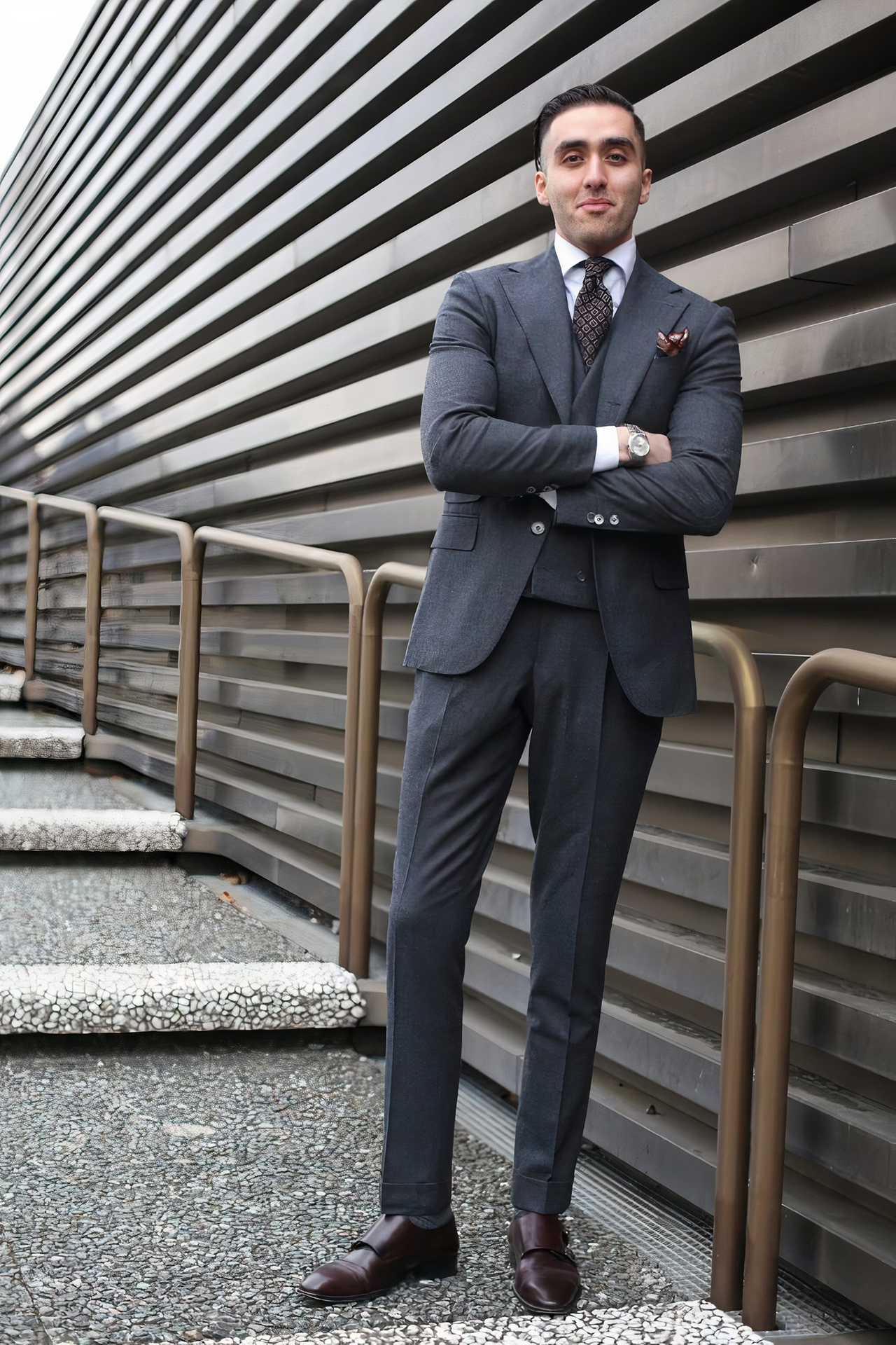 three-piece charcoal suit, white shirt, and dark brown double monks