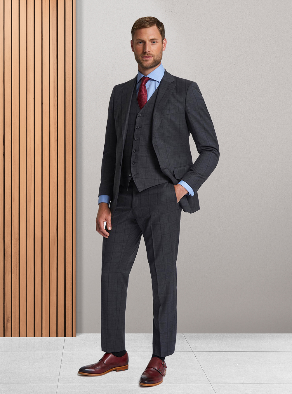 Charcoal windowpane three-piece suit, blue dress shirt, red paisley tie and burgundy double monk straps