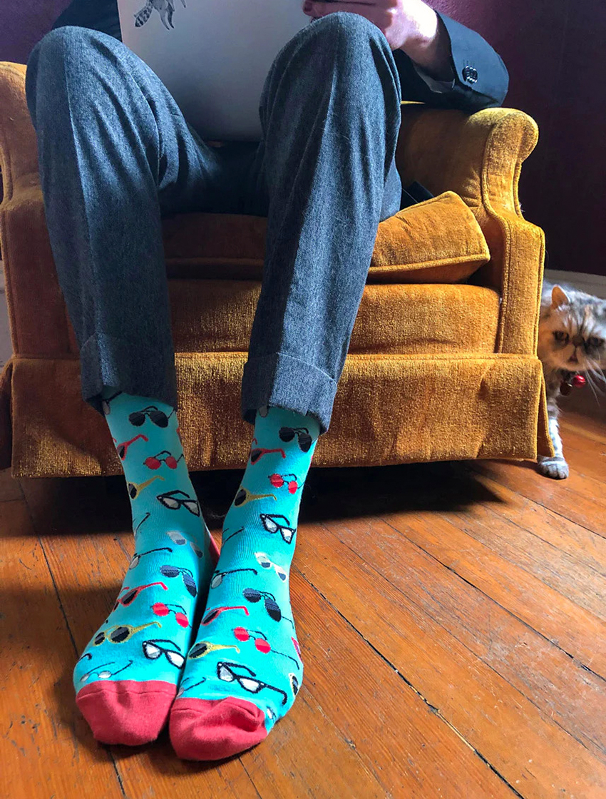 colorful turquoise patterned socks with a blue suit