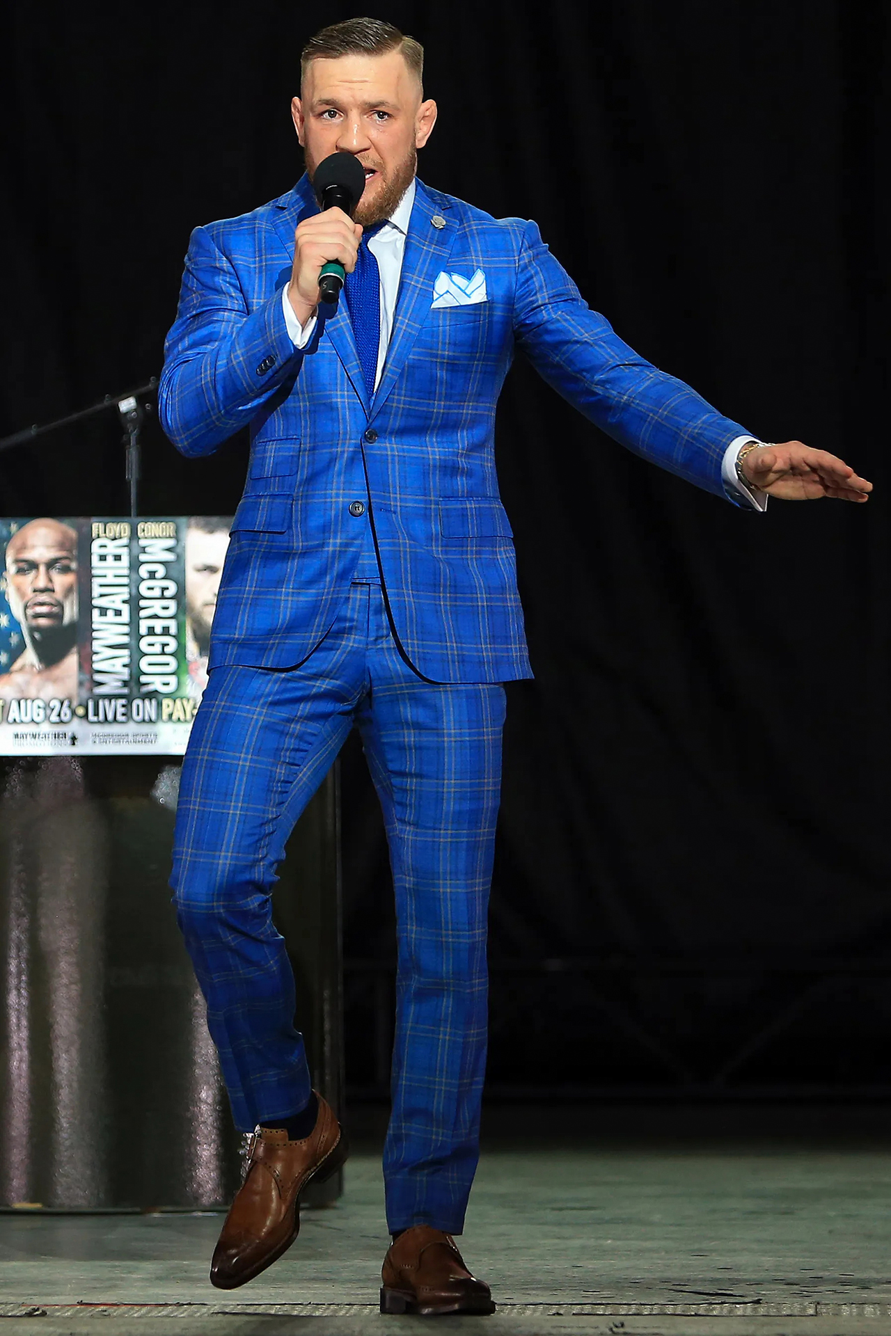 Conor McGregor wears blue checkered suit and brown monk straps