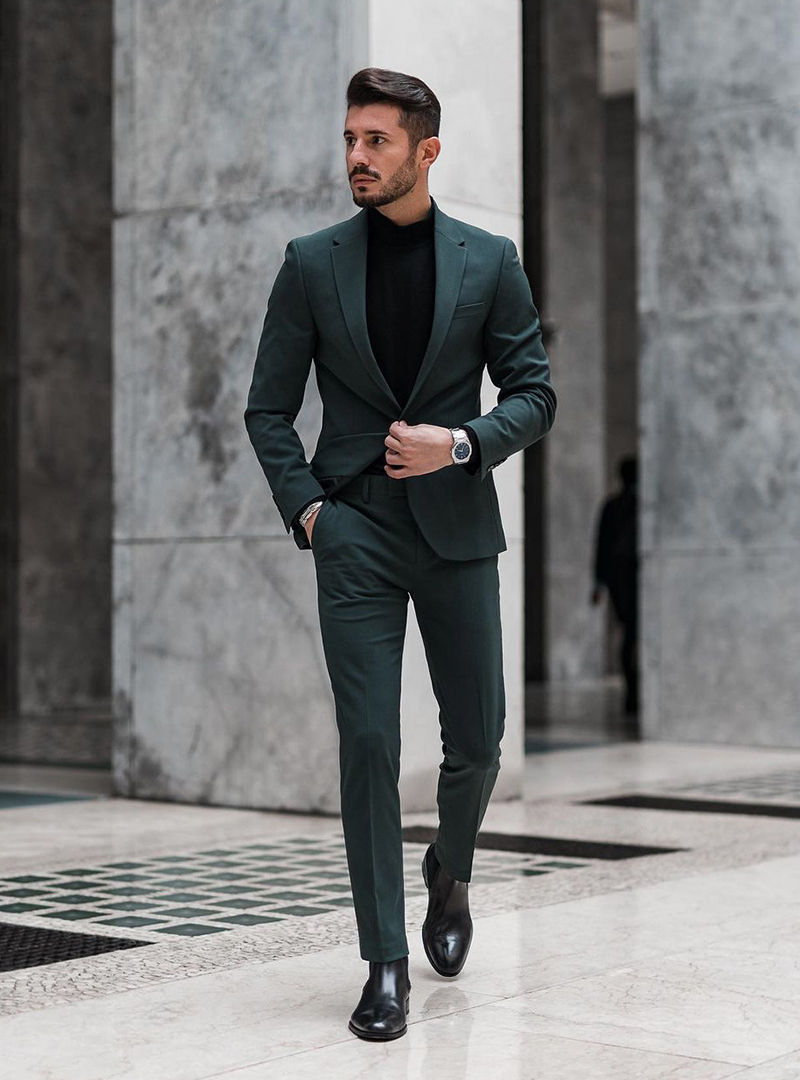 green suit, black turtleneck, and black Chelsea