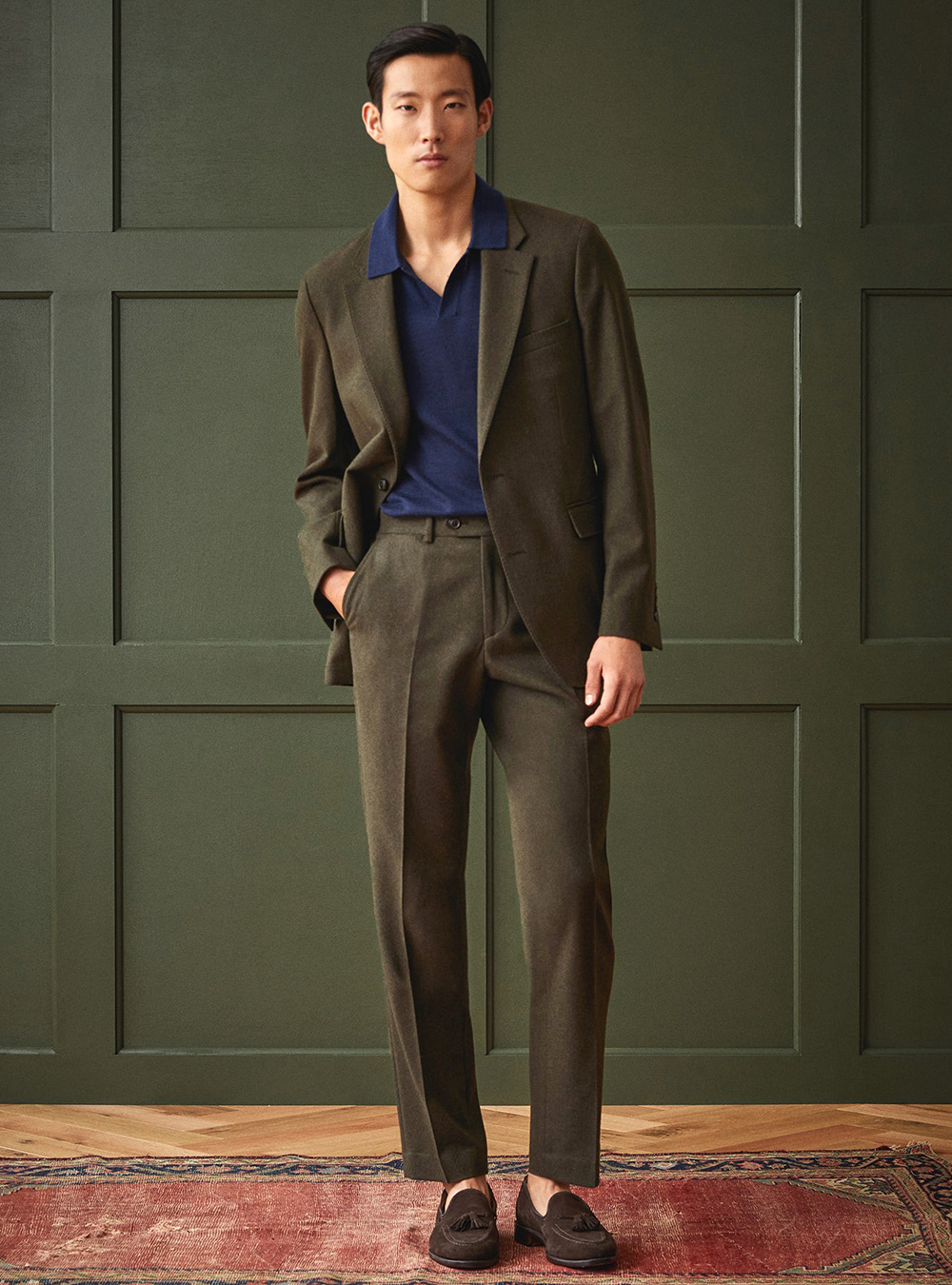 dark green suit, navy polo t-shirt, and brown suede loafers