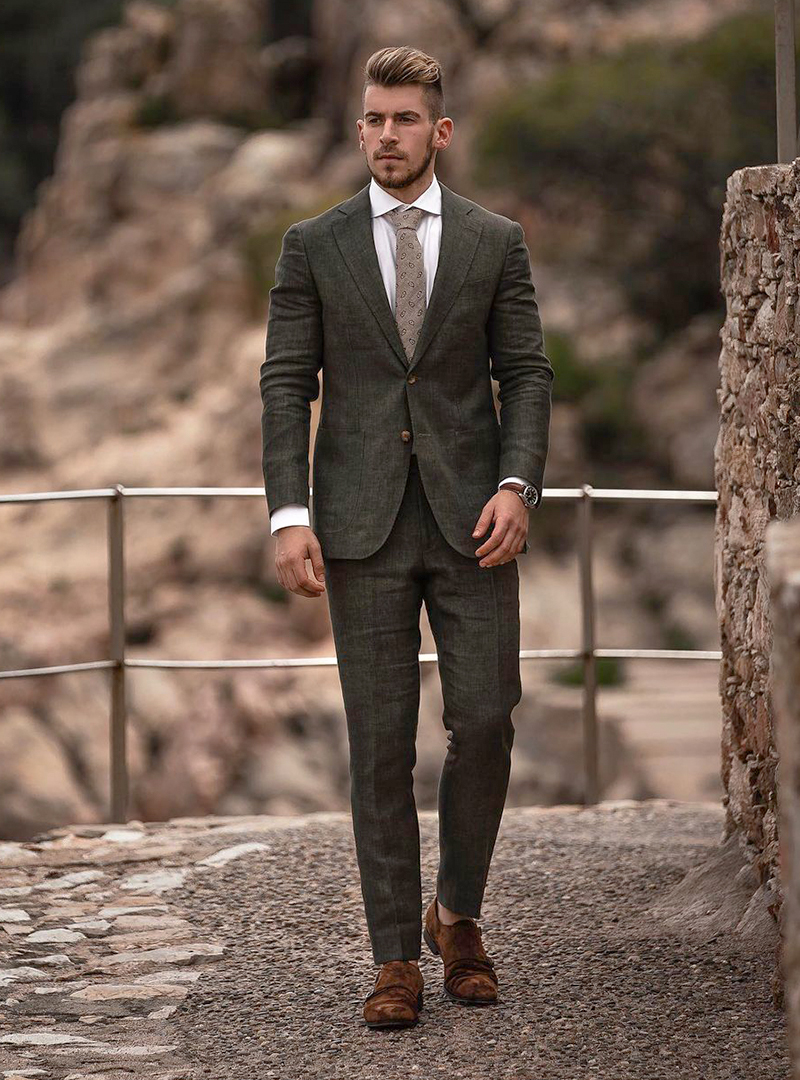 Dark green suit, white dress shirt, brown tie and brown suede double monks