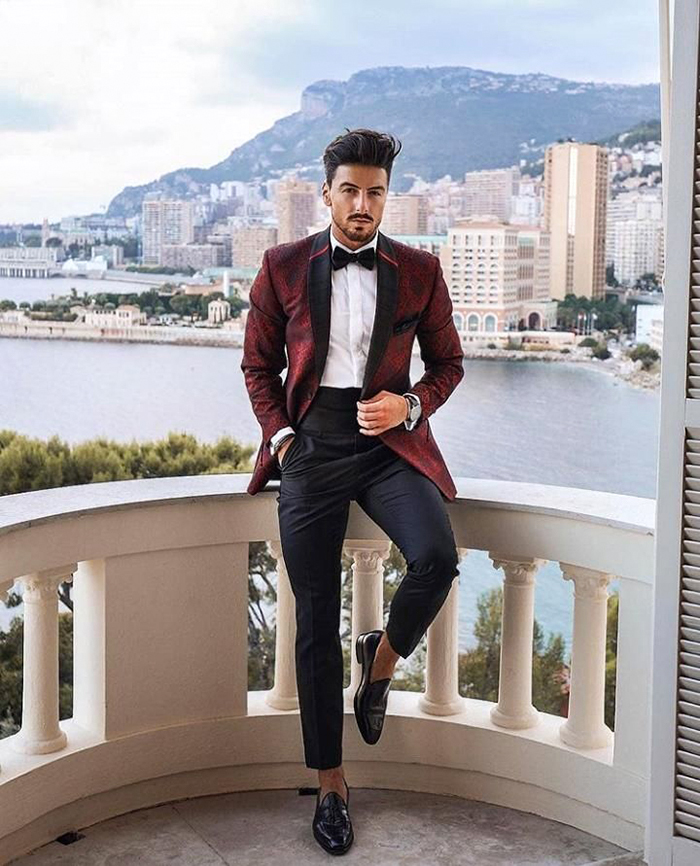 daytime wedding guest in a formal burgundy tuxedo