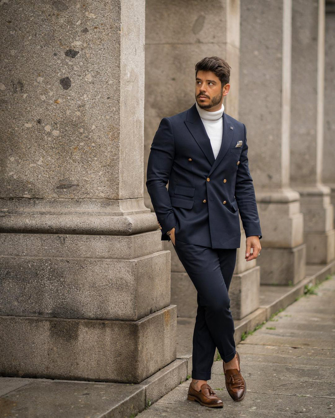 casual wear: double-breasted navy suit, white turtleneck, and brown loafers