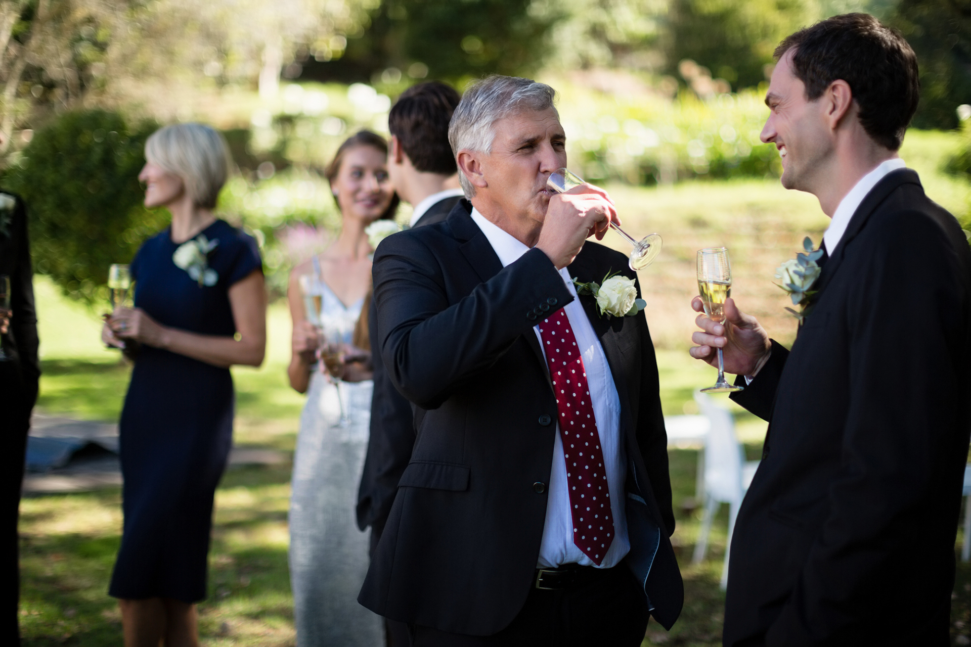 father of the bride in a black suit