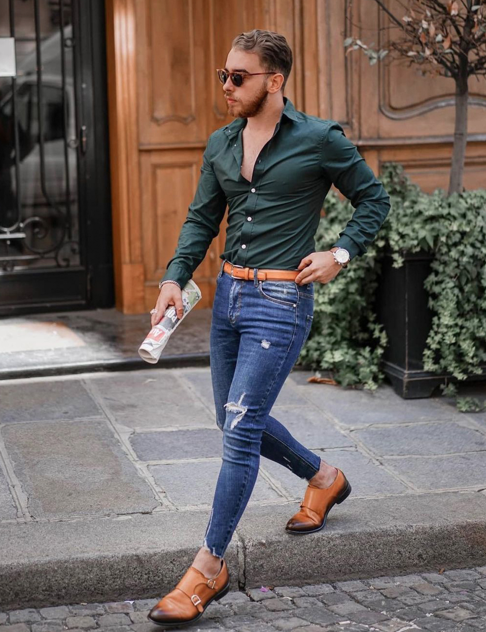 green shirt, blue jeans, and brown monk strap shoes