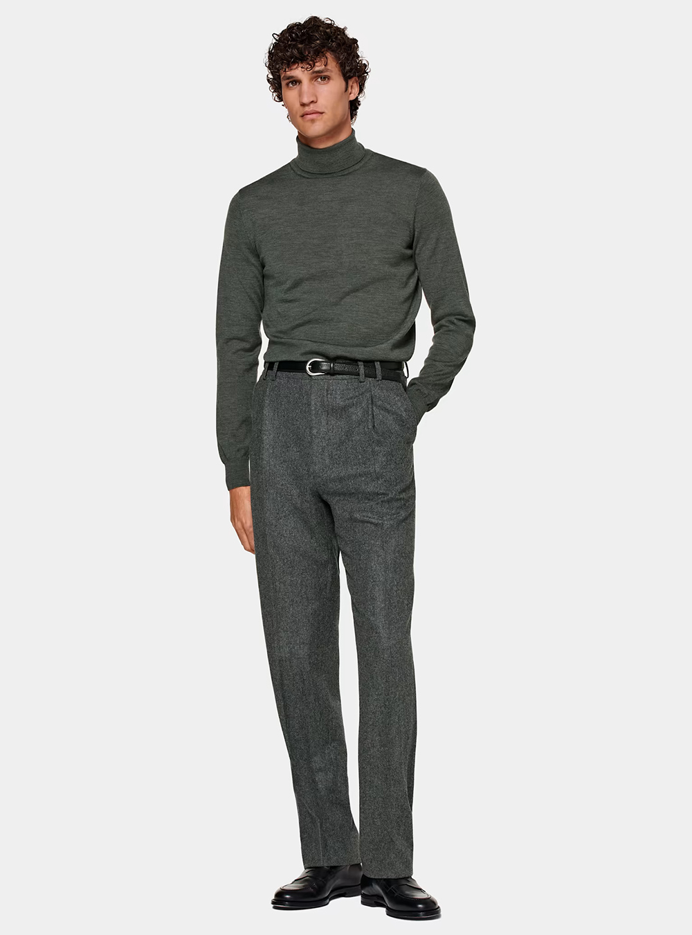 green turtleneck, charcoal dress pants, and black loafers