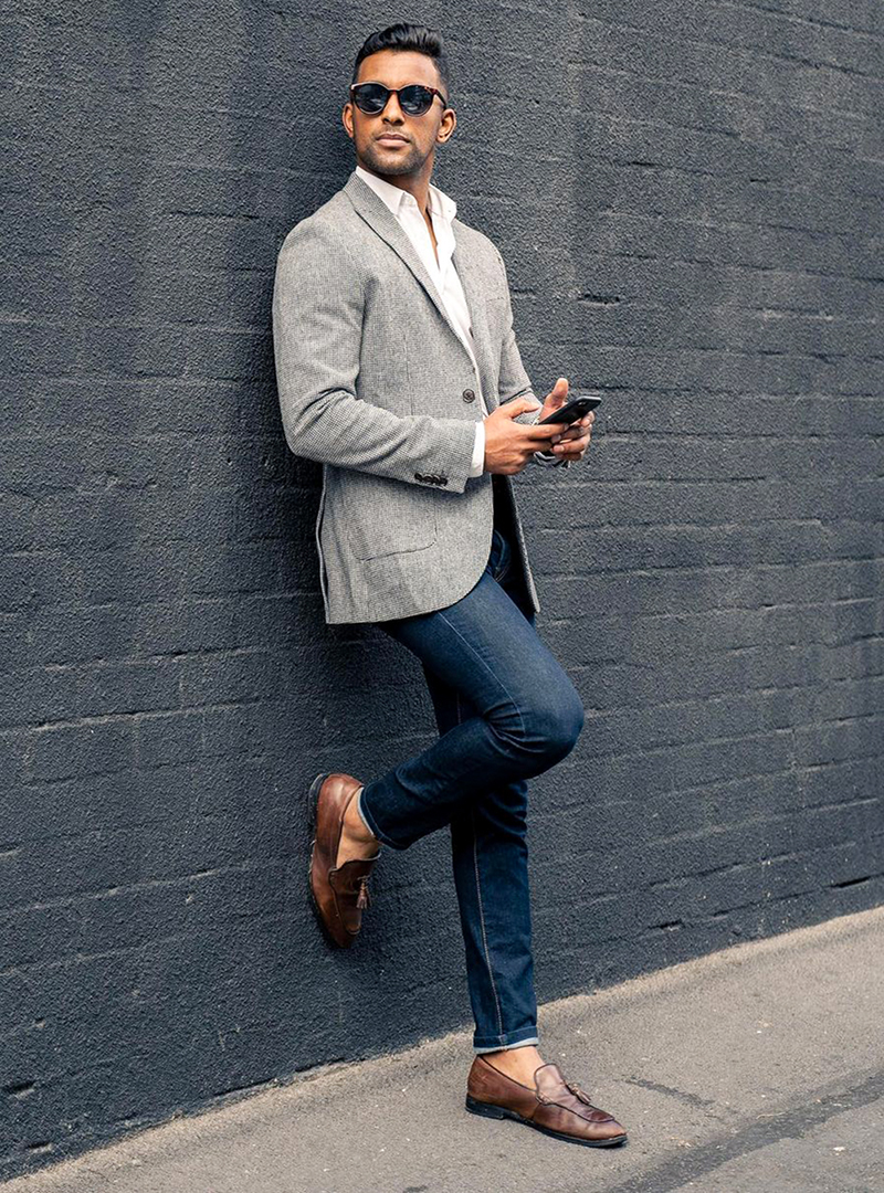 grey blazer, white dress shirt, dark blue jeans, and brown loafers