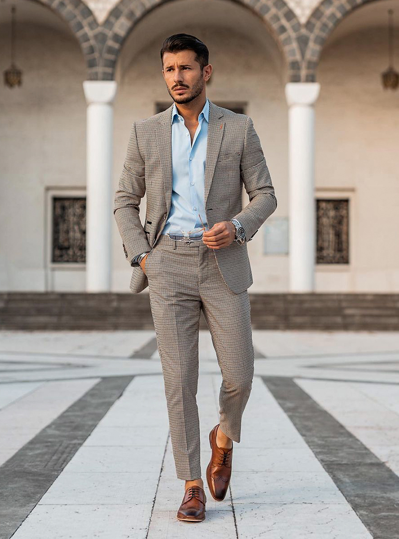 grey checked suit, light blue dress shirt, and brown brogues