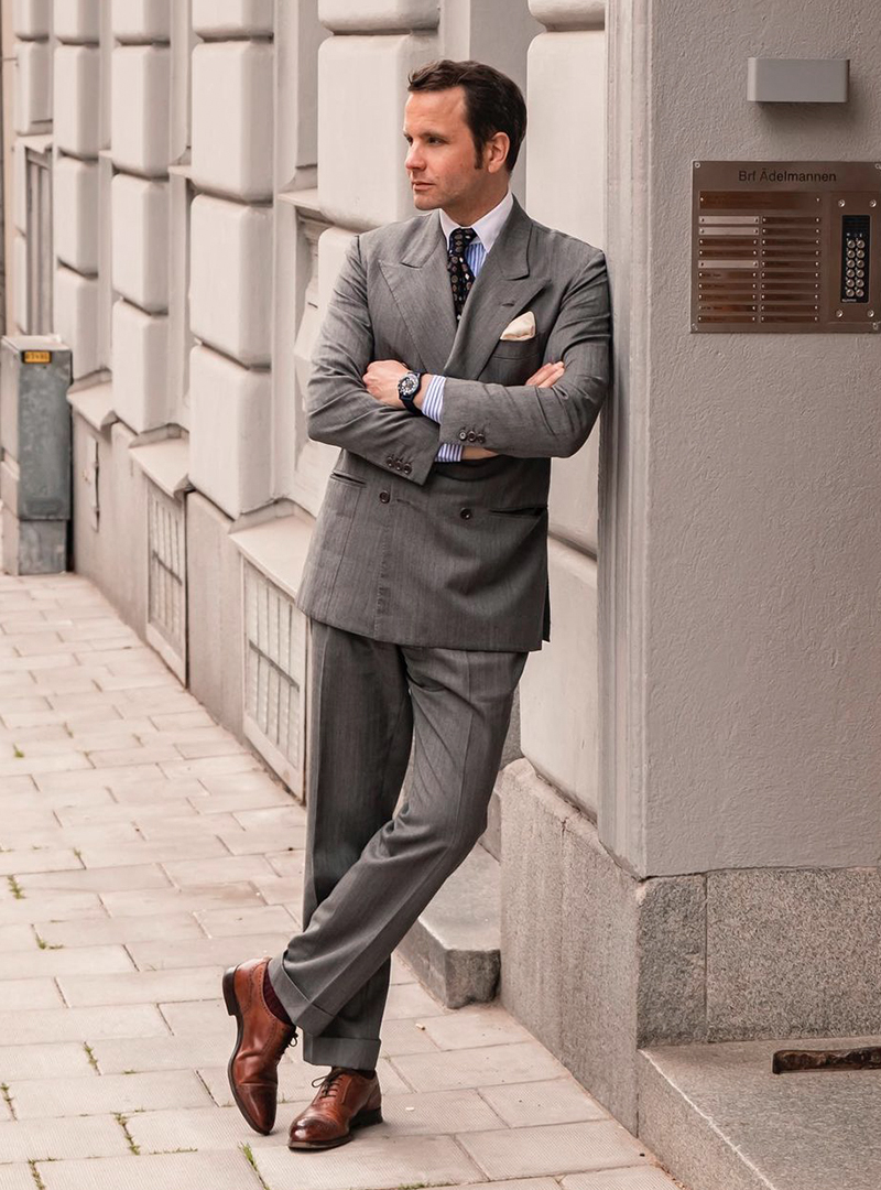 grey double-breasted suit, blue striped white-collar shirt, and brown oxford shoes