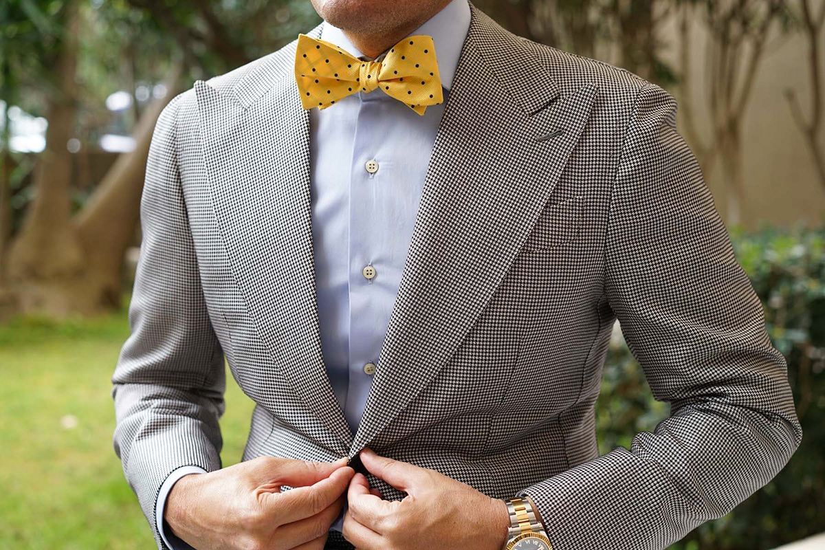 grey suit with a yellow polka dot tie