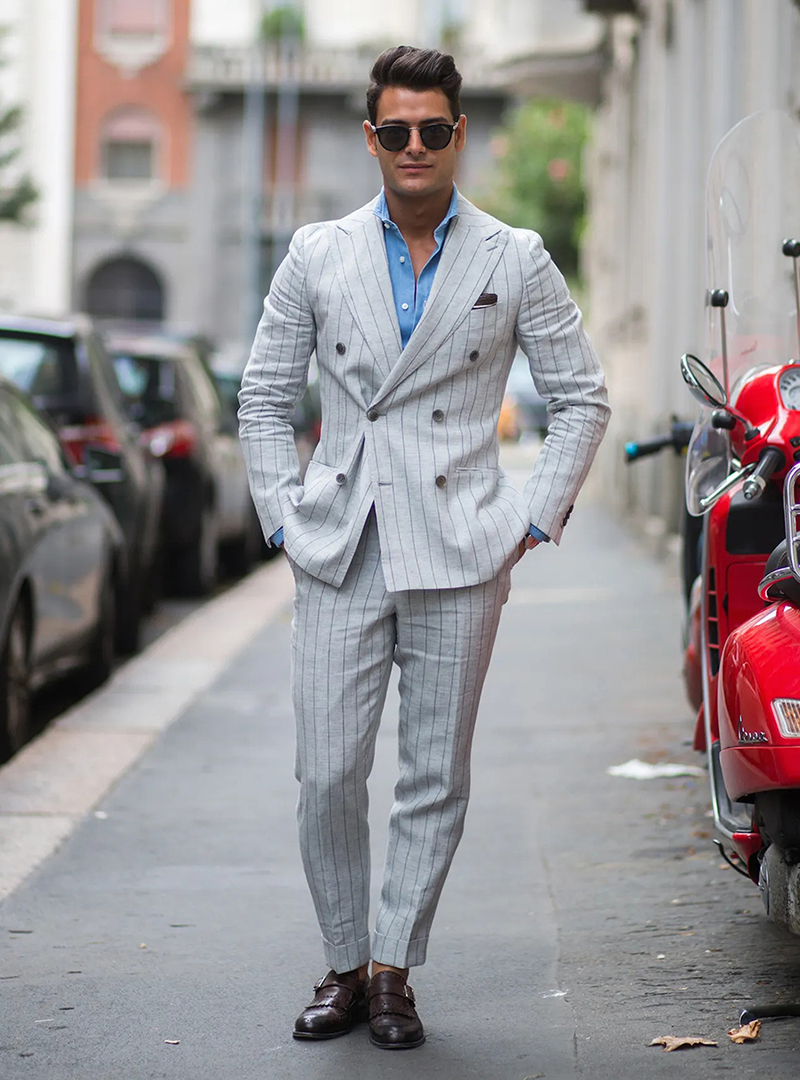 grey double-breasted suit, blue shirt, and brown monk strap shoes