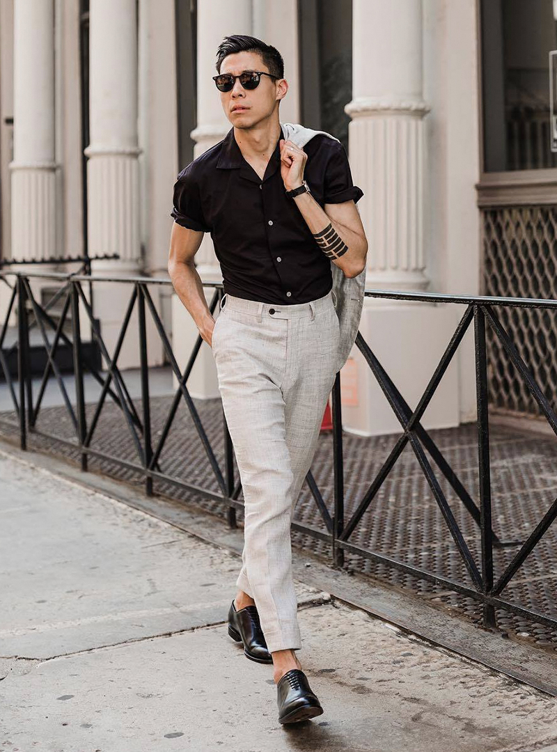 grey suit, black short sleeve shirt, and black Oxford shoes