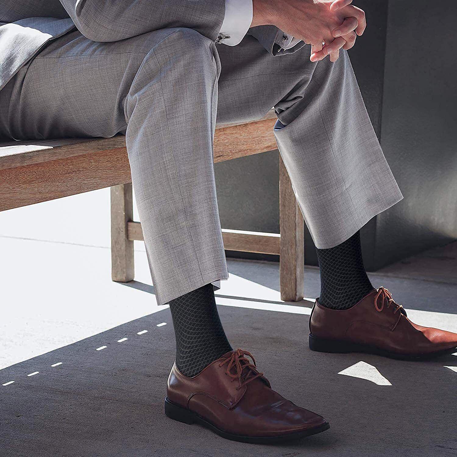 grey suit, black socks, and brown derby shoes
